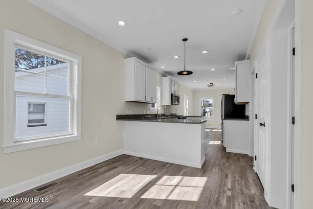 a kitchen with kitchen island white cabinets and counter space