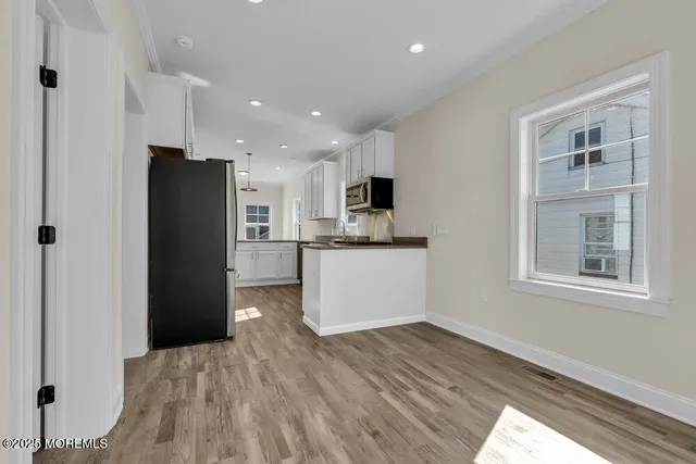 a kitchen with stainless steel appliances a refrigerator and a sink