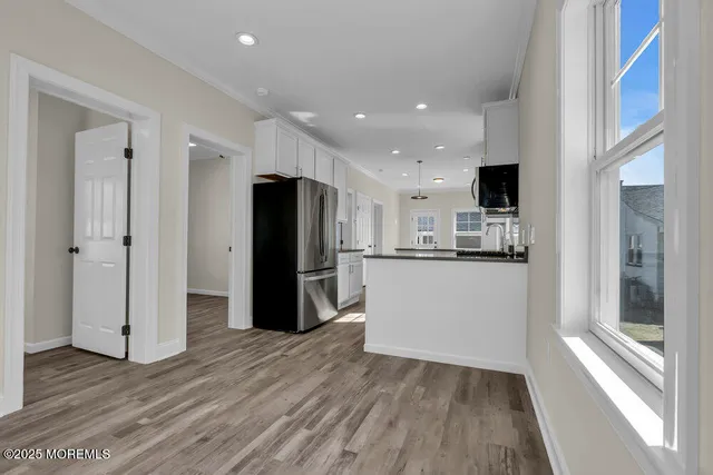 a kitchen with stainless steel appliances a refrigerator and a stove top oven