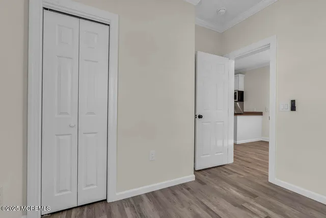 a view of an empty room with wooden floor