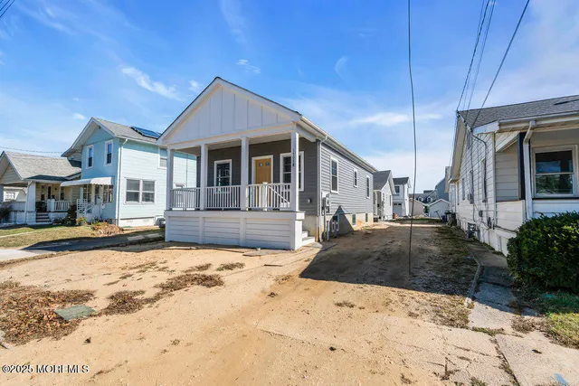 a front view of a house with a yard covered with snow