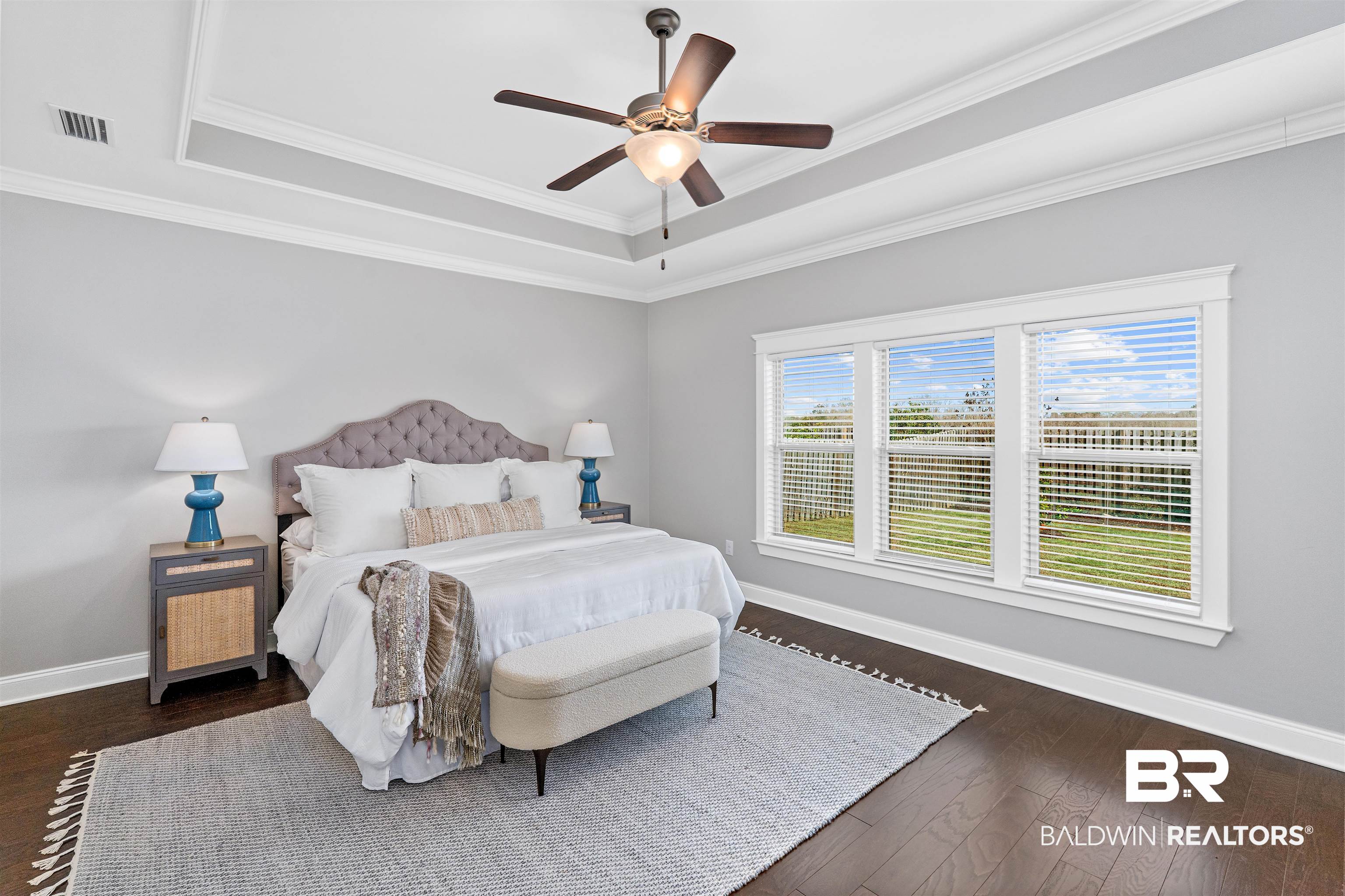 24838 Slater Mill Road Daphne, AL 36526 - Photo 30 of 46 Bedroom with a raised ceiling, dark wood-style floors, a ceiling fan, and crown molding