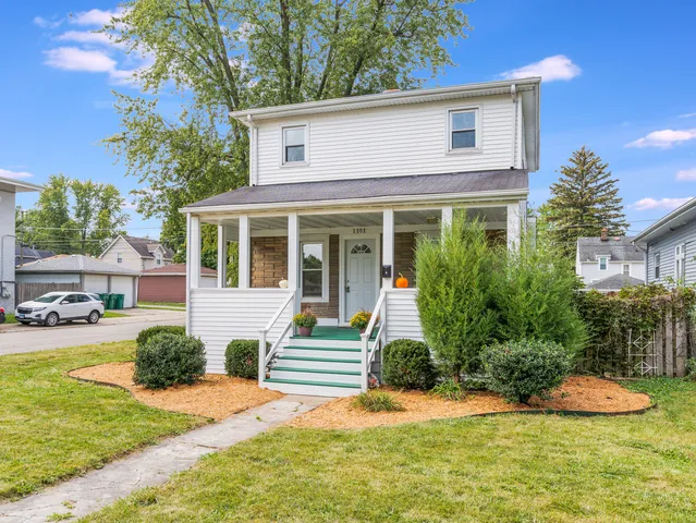 a balcony with furniture and wooden floor