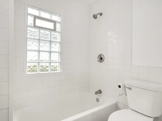 a bathroom with a toilet and a bathtub