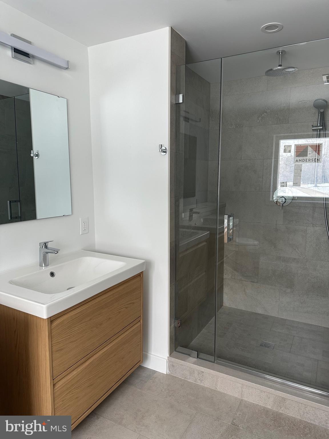 713 Woodfield Road Villanova, PA 19085 - Photo 20 of 33 a bathroom with a sink a shower and a mirror