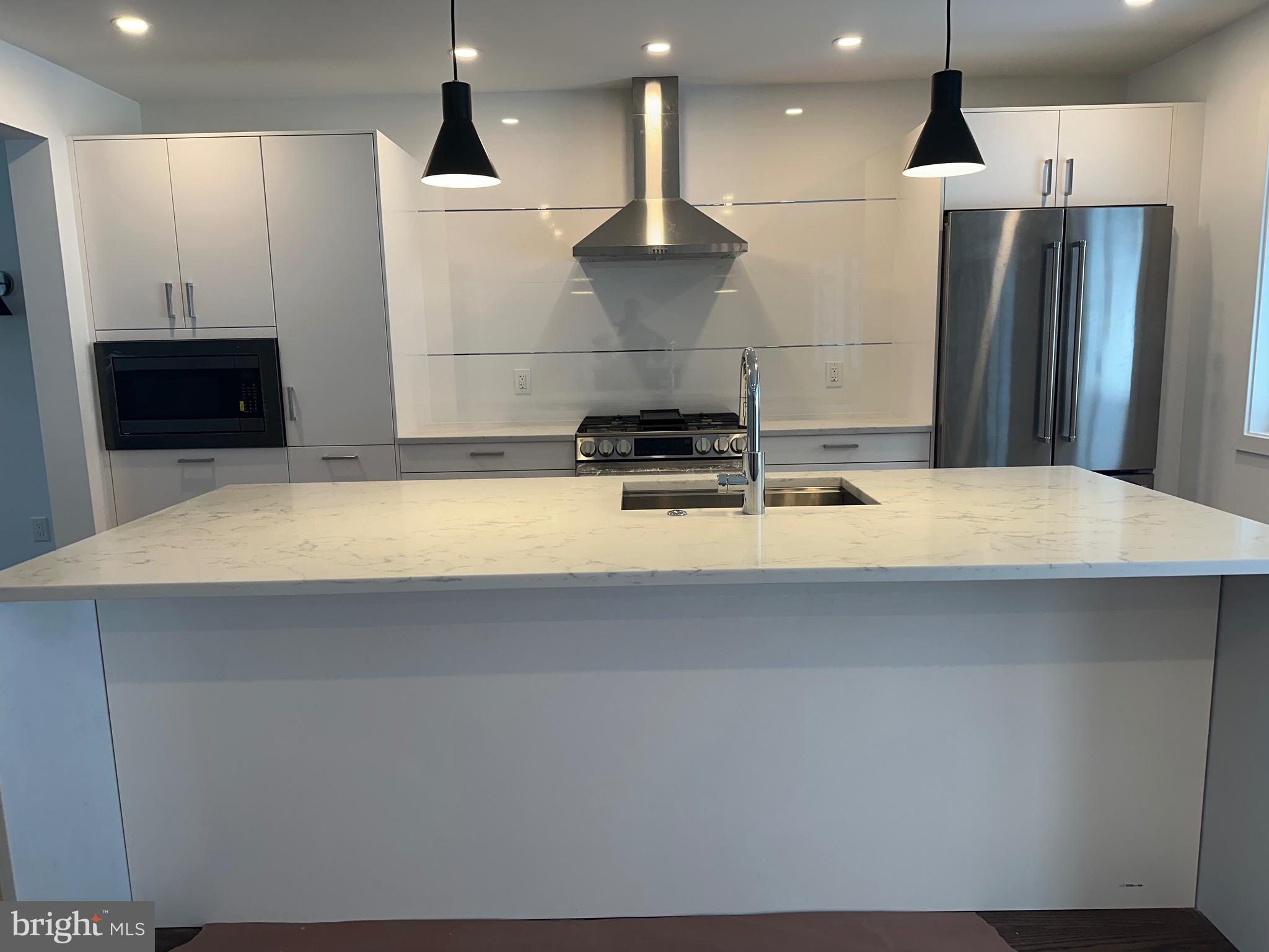 713 Woodfield Road Villanova, PA 19085 - Photo 3 of 33 a kitchen with stainless steel appliances a refrigerator sink and a stove