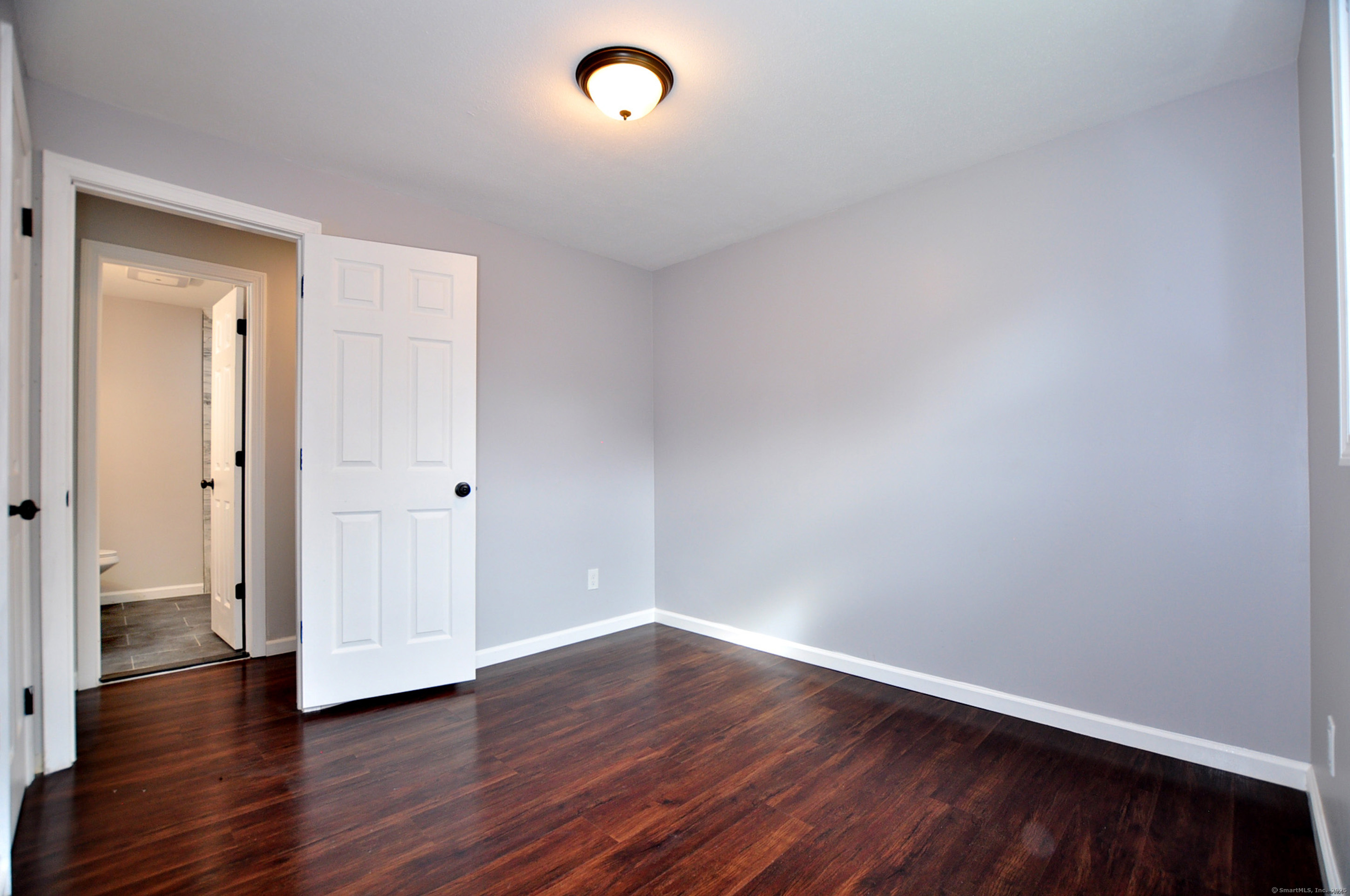 4 Kimann Drive Plymouth, CT 06786 - Photo 11 of 25 a view of an empty room and wooden floor