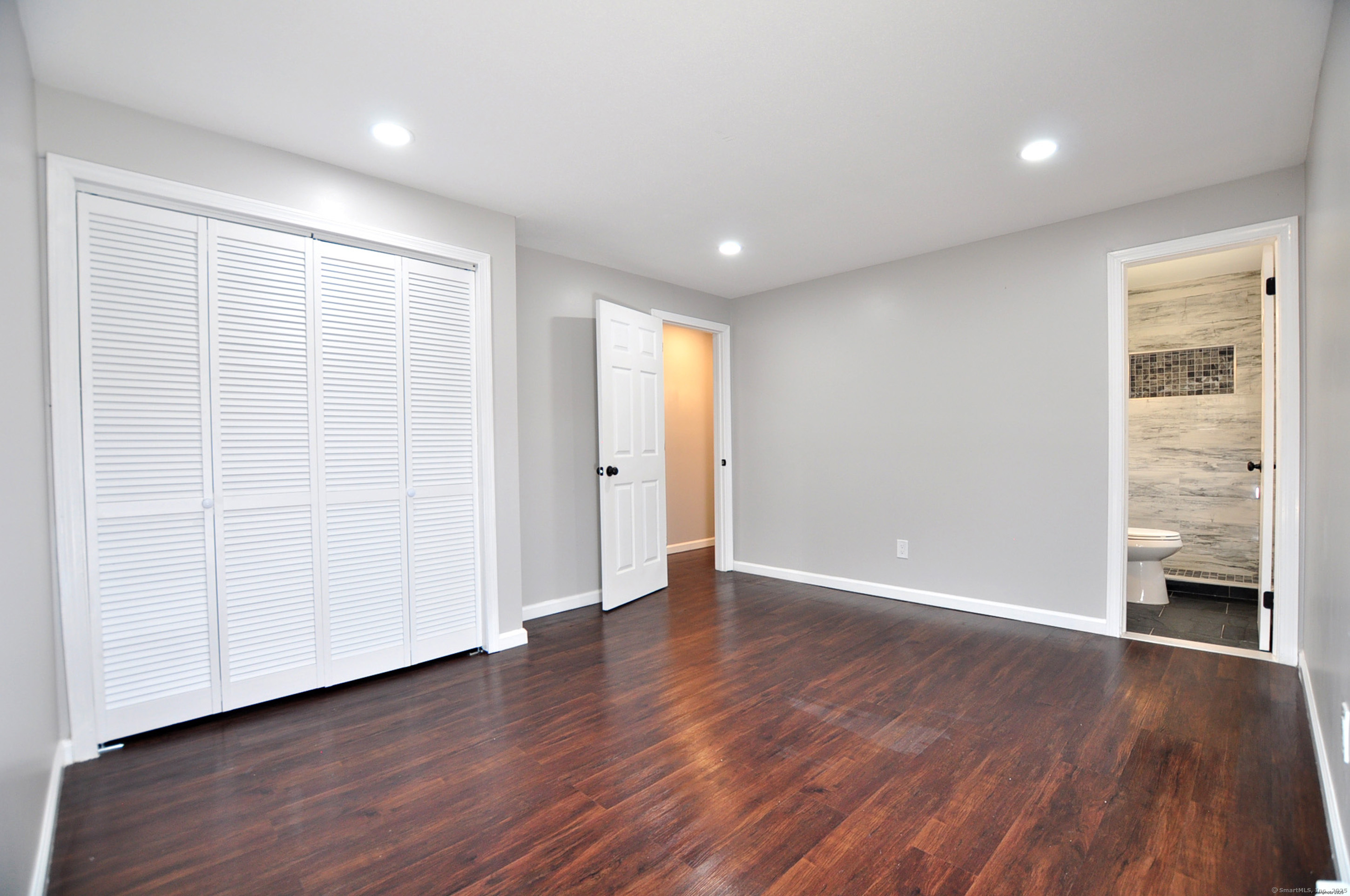 4 Kimann Drive Plymouth, CT 06786 - Photo 16 of 25 a view of an empty room with wooden floor and a window