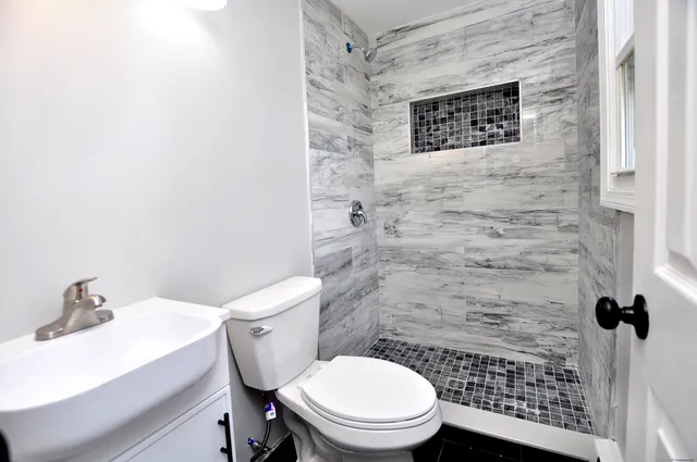 a bathroom with a toilet and a shower