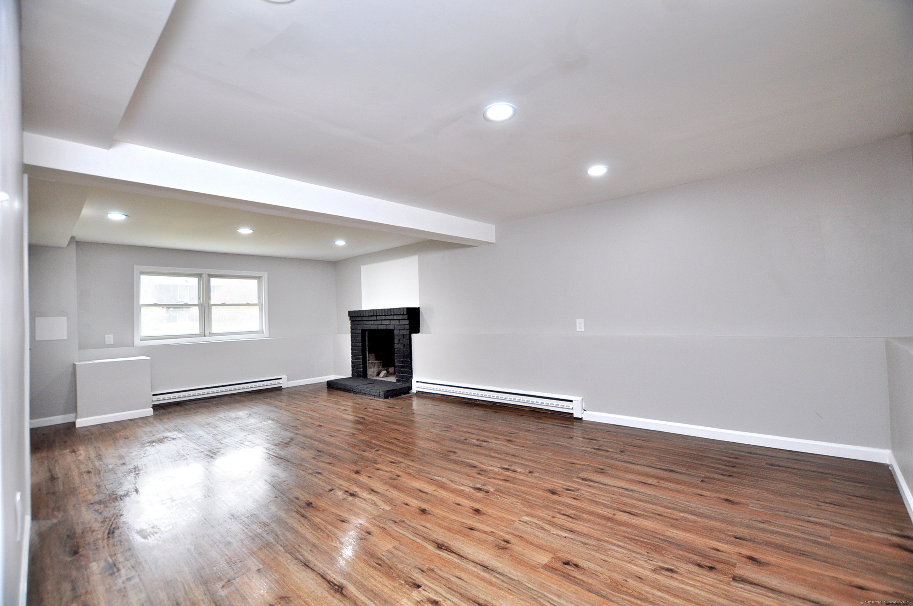 4 Kimann Drive Plymouth, CT 06786 - Photo 20 of 25 a view of an empty room with wooden floor and a window