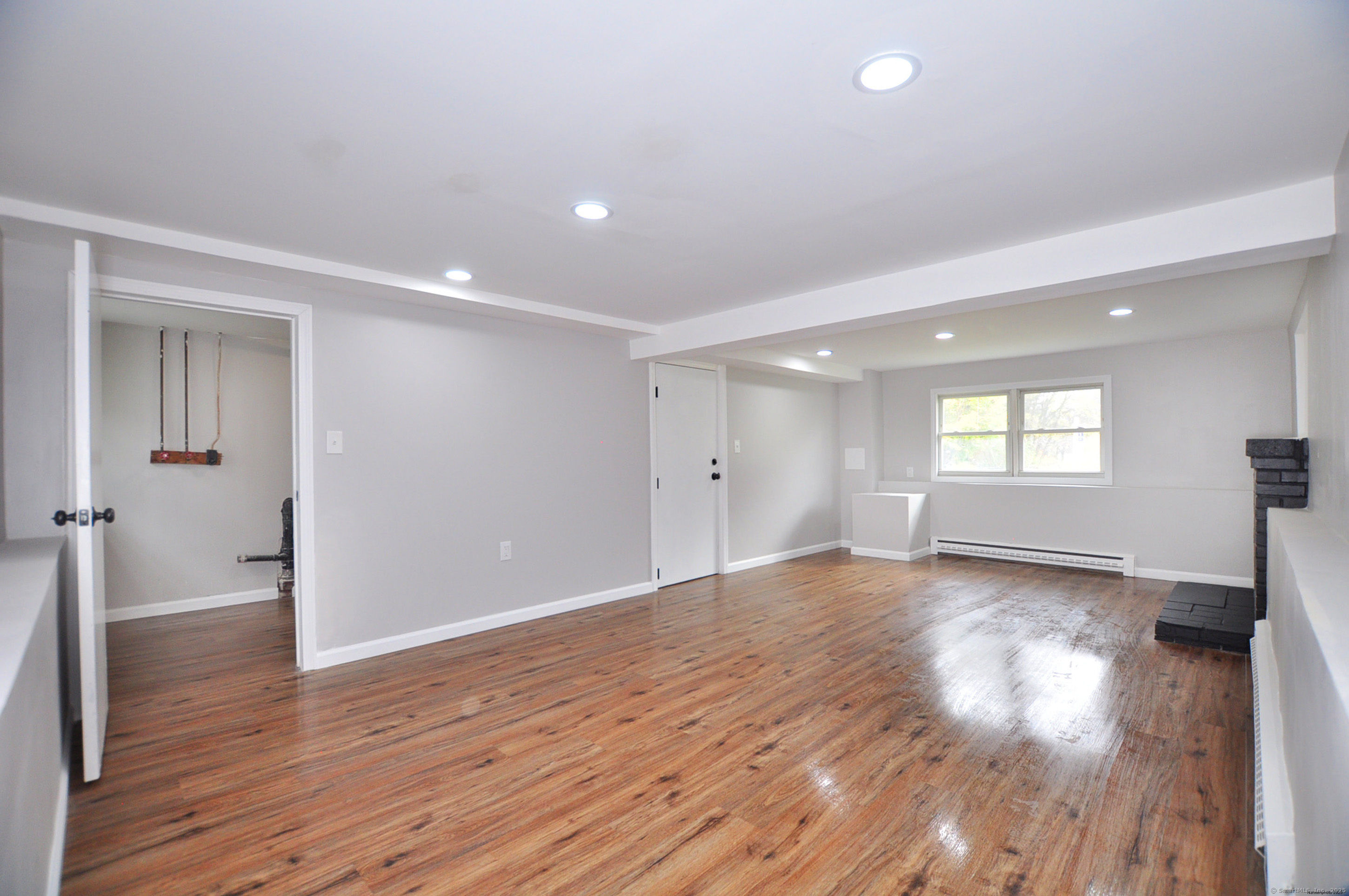 4 Kimann Drive Plymouth, CT 06786 - Photo 21 of 25 an empty room with wooden floor and windows