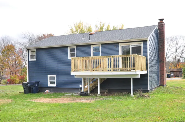 a backyard of a house with yard and trampoline