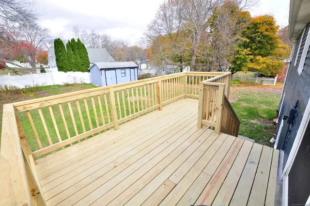 a view of balcony with wooden floor and fence
