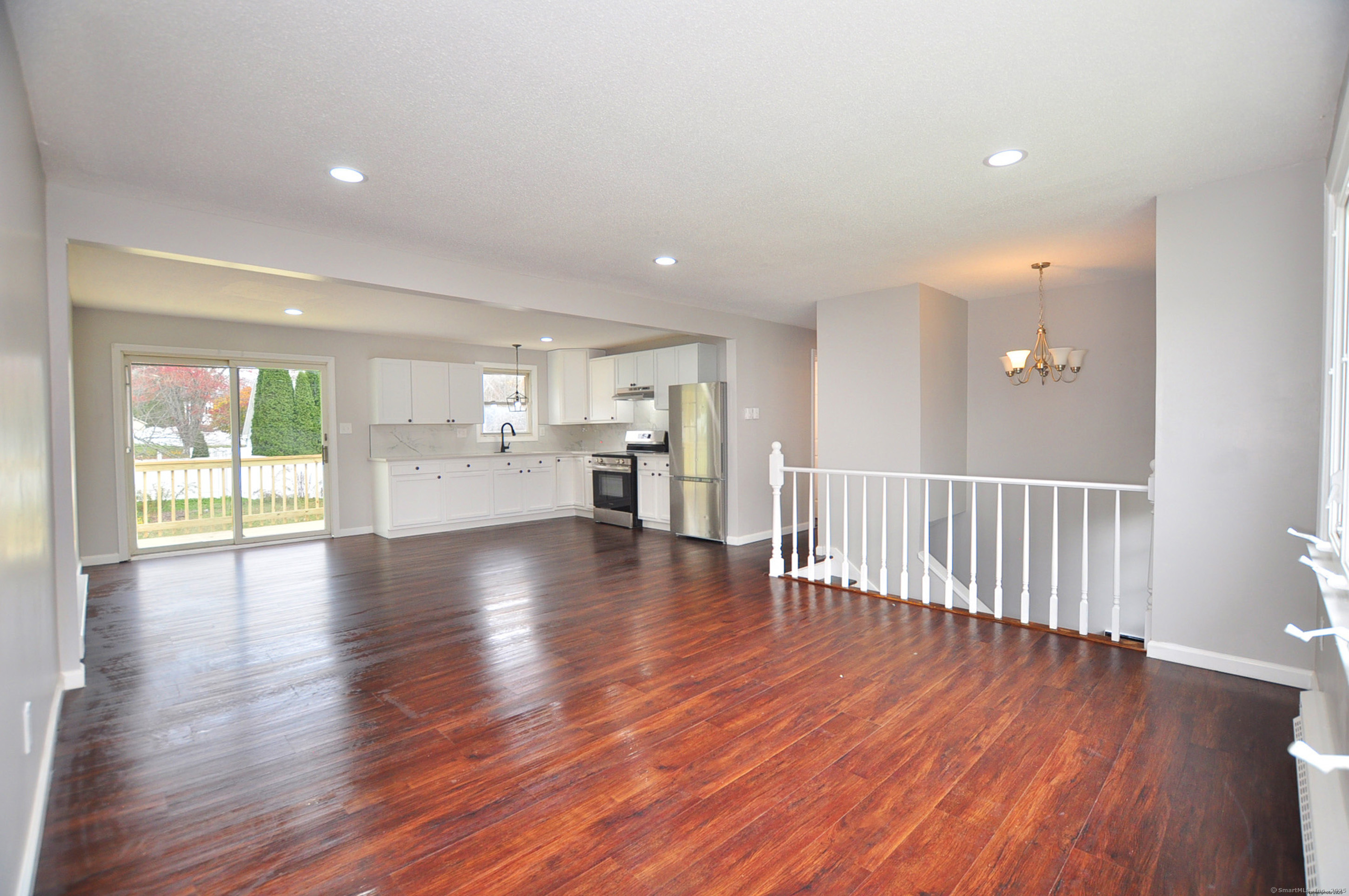 4 Kimann Drive Plymouth, CT 06786 - Photo 6 of 25 a view of empty room with wooden floor and windows