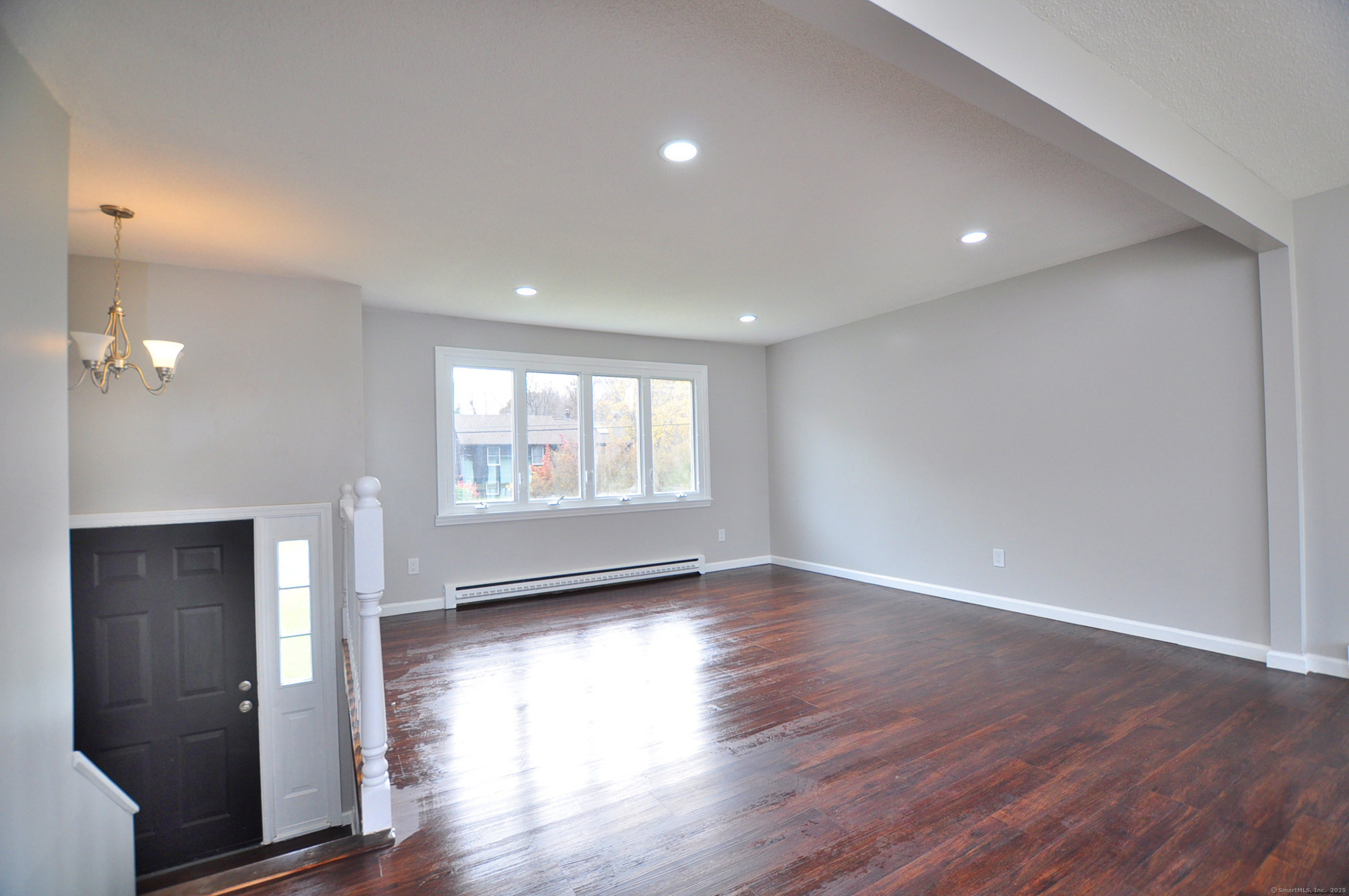 4 Kimann Drive Plymouth, CT 06786 - Photo 7 of 25 a view of an empty room with wooden floor and a window
