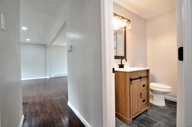 a bathroom with a sink a toilet and shower