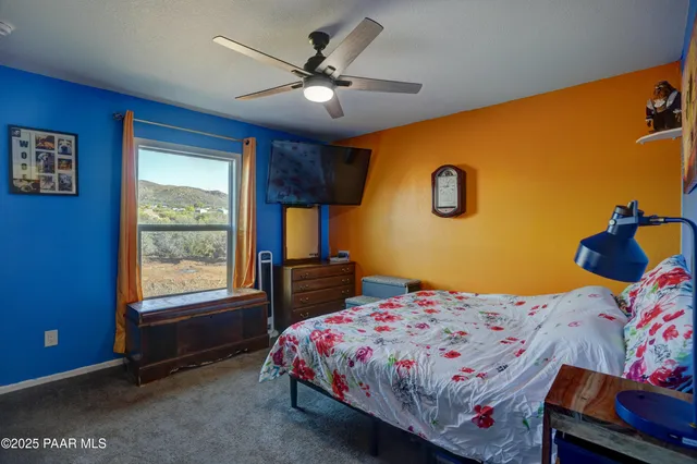 a bedroom that has a bed and a chandelier