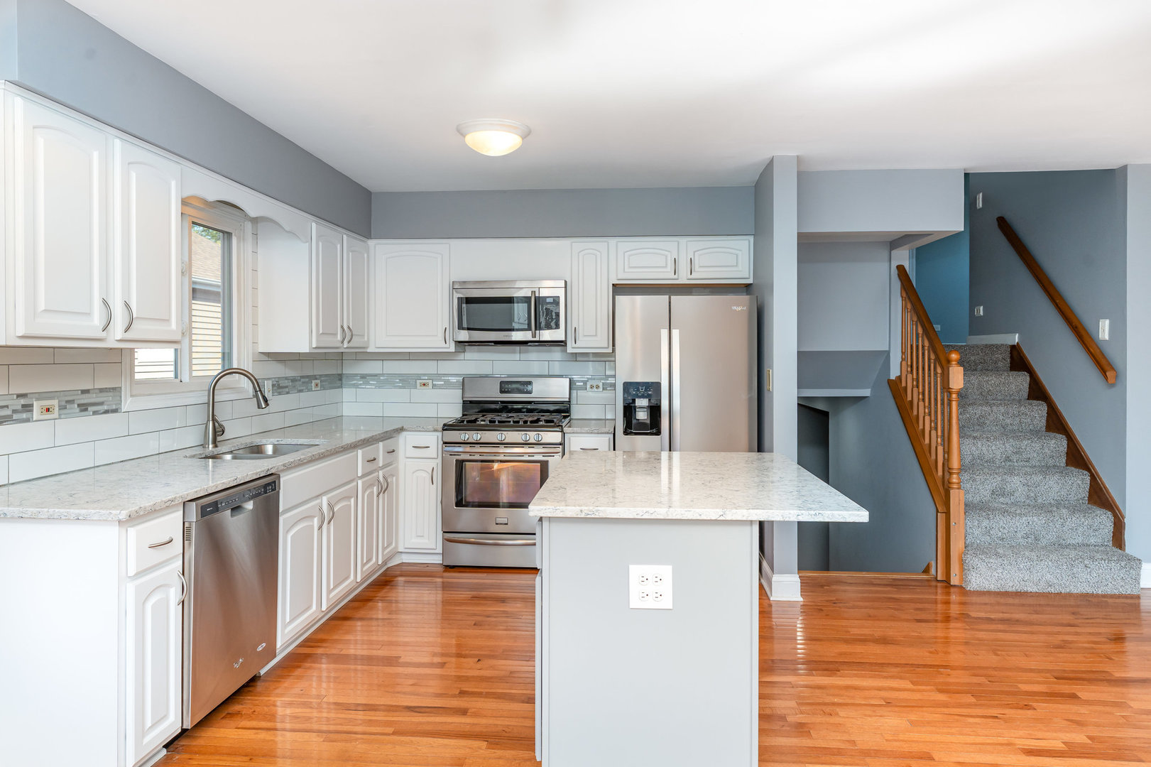 S045 Pleasant Hill Road Wheaton, IL 60187 - Photo 7 of 31 a kitchen with stainless steel appliances granite countertop a sink stove microwave and refrigerator