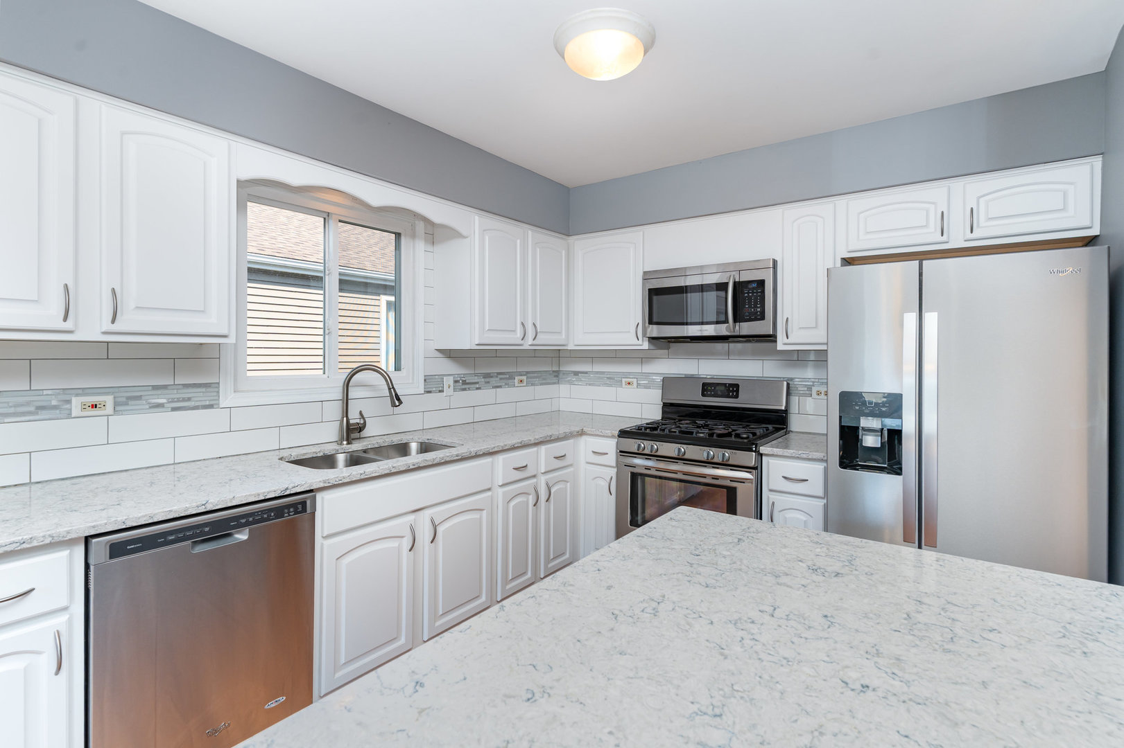 S045 Pleasant Hill Road Wheaton, IL 60187 - Photo 8 of 31 a kitchen with a sink stove and refrigerator