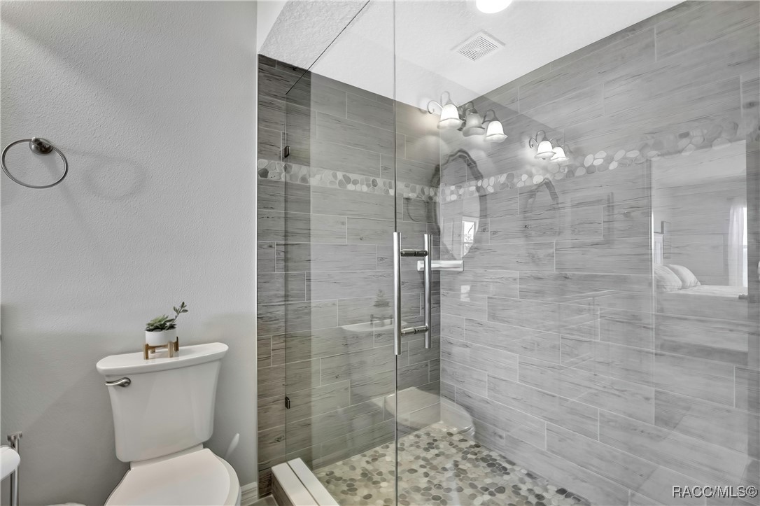 2855 North Rivers Edge Boulevard, Unit 213 Crystal River, FL 34429 - Photo 28 of 62 a bathroom with a toilet sink and shower
