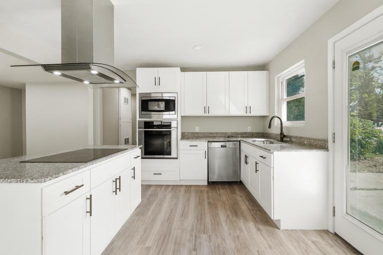 2116 Ridgeway Street Arlington, TX 76010 - Photo 12 of 21 a kitchen with granite countertop a sink stove and refrigerator