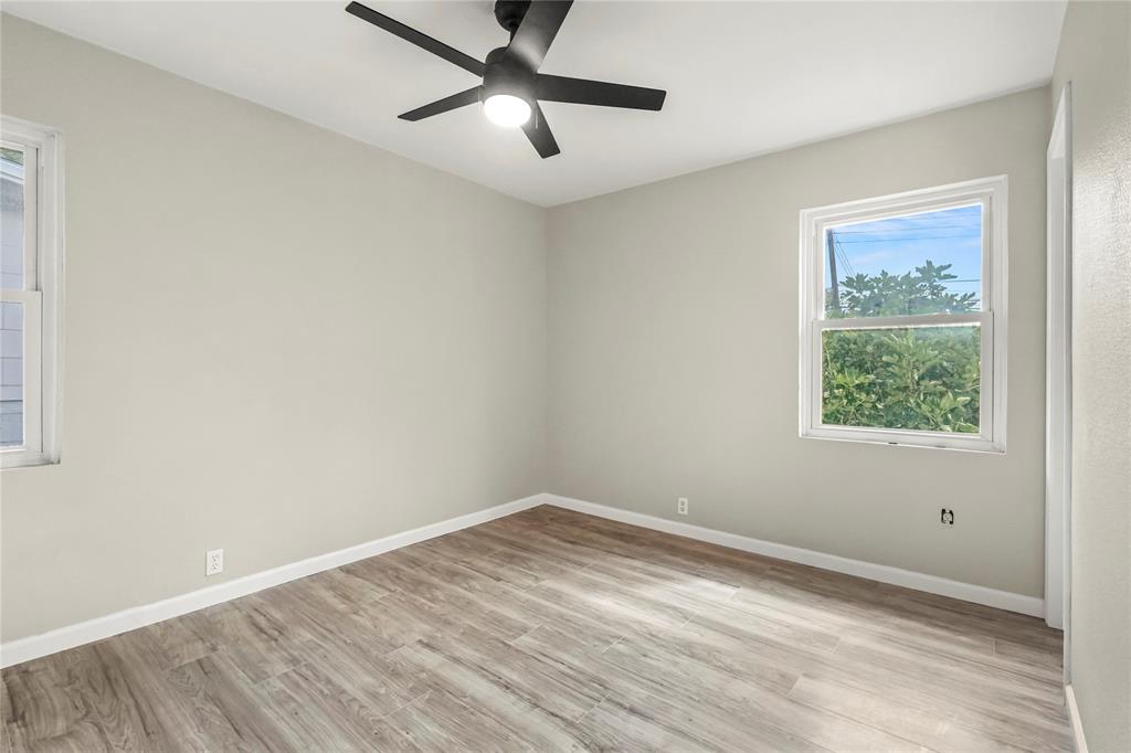 2116 Ridgeway Street Arlington, TX 76010 - Photo 14 of 21 an empty room with a window and a ceiling fan
