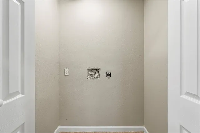 an empty room with a window and wooden floor