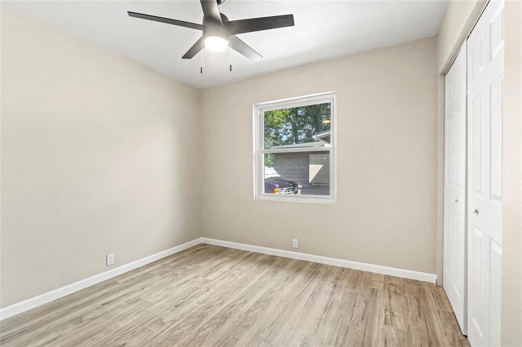 2116 Ridgeway Street Arlington, TX 76010 - Photo 18 of 21 an empty room with a window and wooden floor