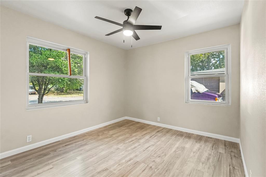 2116 Ridgeway Street Arlington, TX 76010 - Photo 19 of 21 a view of empty room with wooden floor and fan