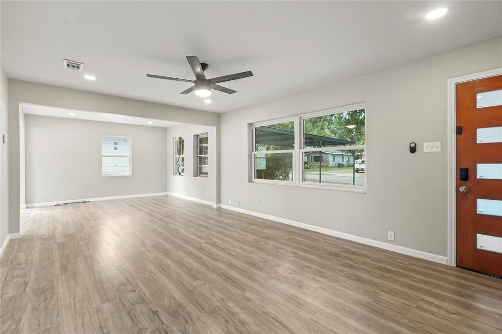 2116 Ridgeway Street Arlington, TX 76010 - Photo 4 of 21 a view of an empty room with wooden floor and a window