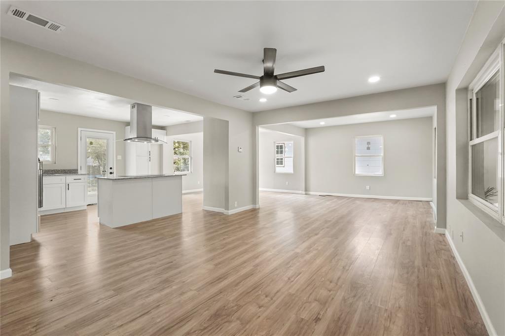 2116 Ridgeway Street Arlington, TX 76010 - Photo 6 of 21 a view of an empty room and window wooden floor and a kitchen