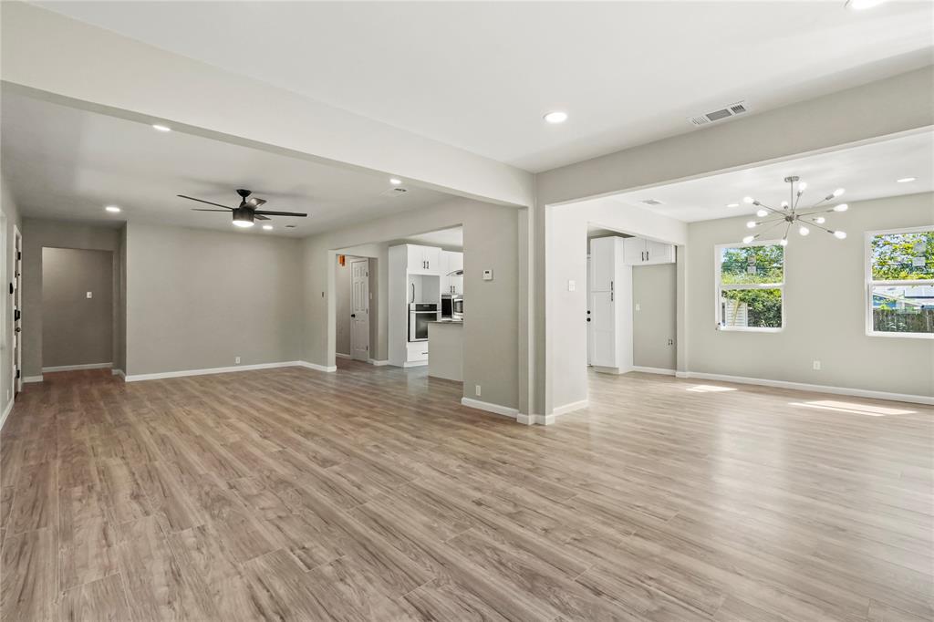 2116 Ridgeway Street Arlington, TX 76010 - Photo 8 of 21 a view of an empty room with wooden floor and a window