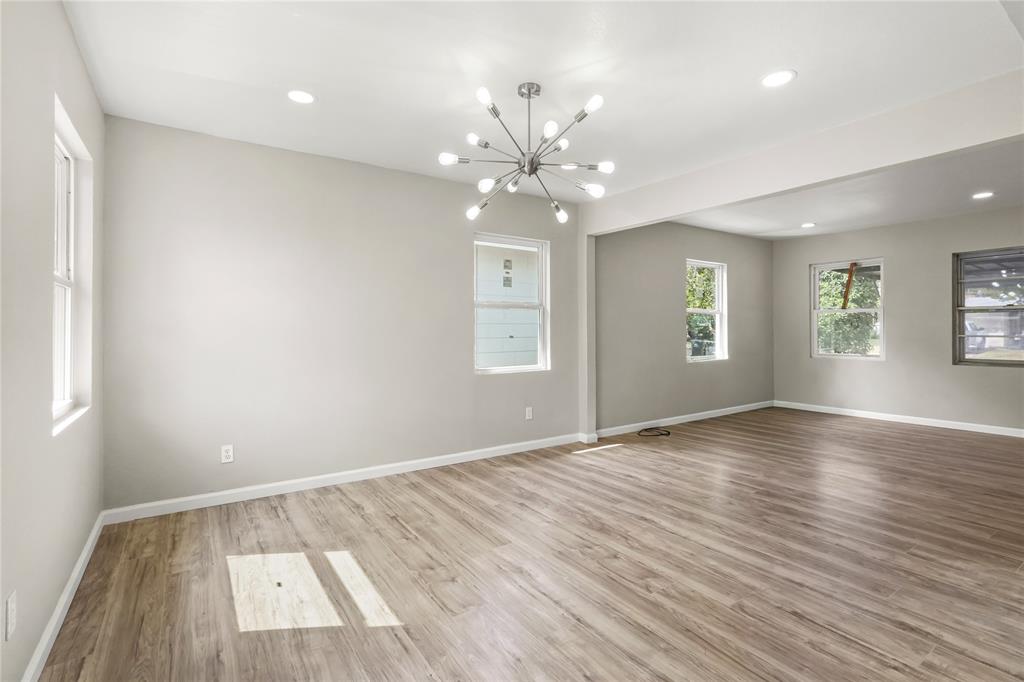2116 Ridgeway Street Arlington, TX 76010 - Photo 9 of 21 wooden floor in an empty room with a window