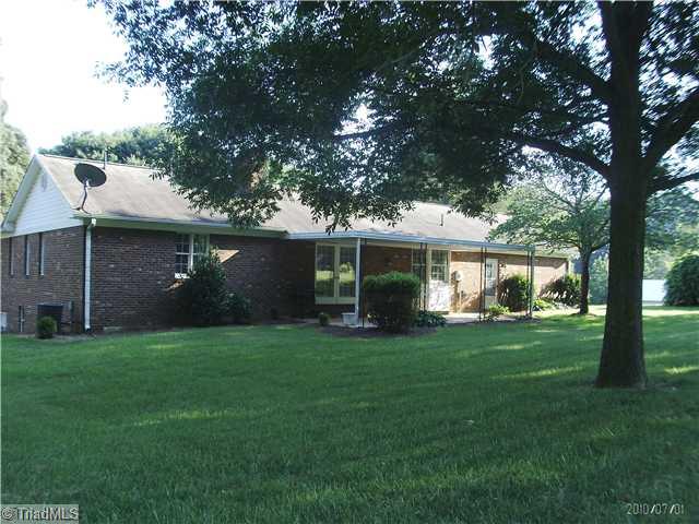 137 4 Brooks Road Winston-Salem, NC 27107 - Photo 3 of 15 Exterior Back. large patio connects spaces from home to expansive back yard