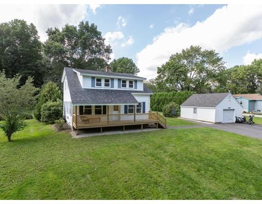 62 Hadley Road Merrimac, MA 01860 - Photo 1 of 23 a house that is sitting in the grass with large trees and plants