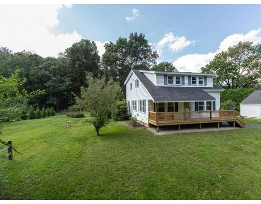 62 Hadley Road Merrimac, MA 01860 - Photo 22 of 23 a house that is sitting in the grass with large trees and plants