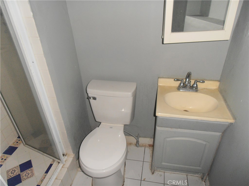 7514 Beckford Avenue Reseda, CA 91335 - Photo 13 of 20 a white toilet sitting next to a bathroom sink
