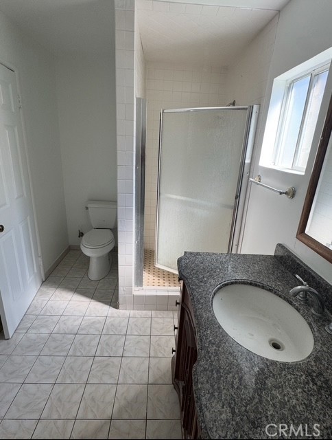 7514 Beckford Avenue Reseda, CA 91335 - Photo 17 of 20 a bathroom with a granite countertop sink a toilet and a mirror