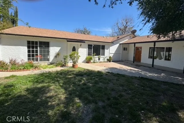 a front view of a house with outdoor seating yard