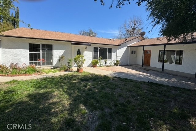 7514 Beckford Avenue Reseda, CA 91335 - Photo 2 of 20 a front view of a house with outdoor seating yard