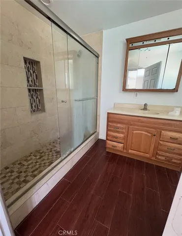 a bathroom with a sink a mirror and shower