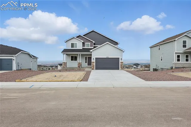 a view of house with outdoor space and parking