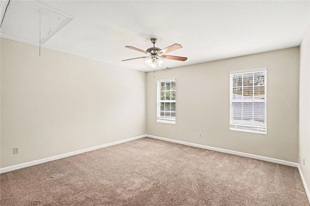 120 Beaverdam Court Covington, GA 30016 - Photo 12 of 20 an empty room with windows and chandelier fan