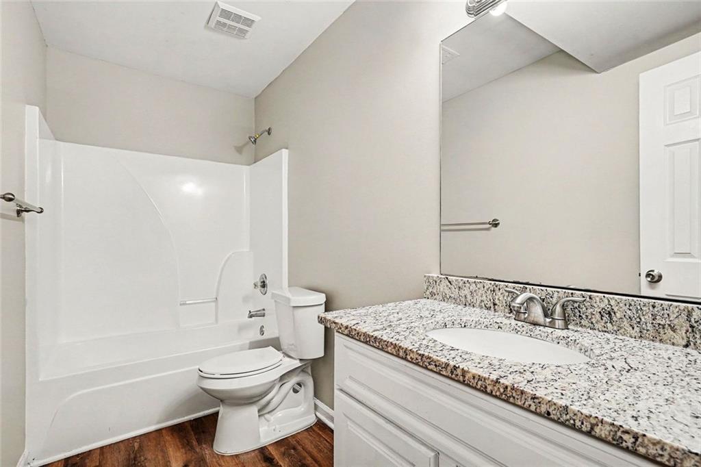 120 Beaverdam Court Covington, GA 30016 - Photo 14 of 20 a bathroom with a granite countertop sink toilet and shower