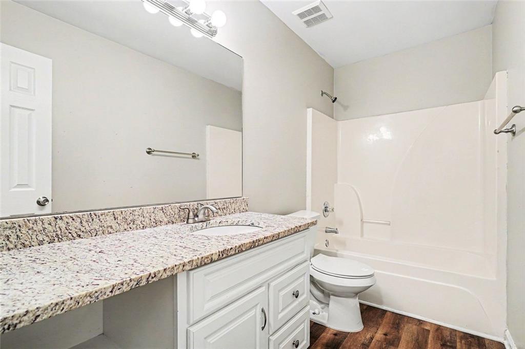 120 Beaverdam Court Covington, GA 30016 - Photo 15 of 20 a bathroom with a granite countertop sink a toilet and shower