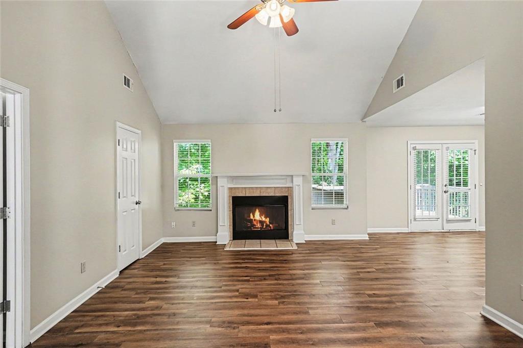 120 Beaverdam Court Covington, GA 30016 - Photo 3 of 20 a view of an empty room with wooden floor fireplace and a window