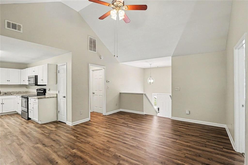120 Beaverdam Court Covington, GA 30016 - Photo 4 of 20 a view of a kitchen with wooden floor and a ceiling fan