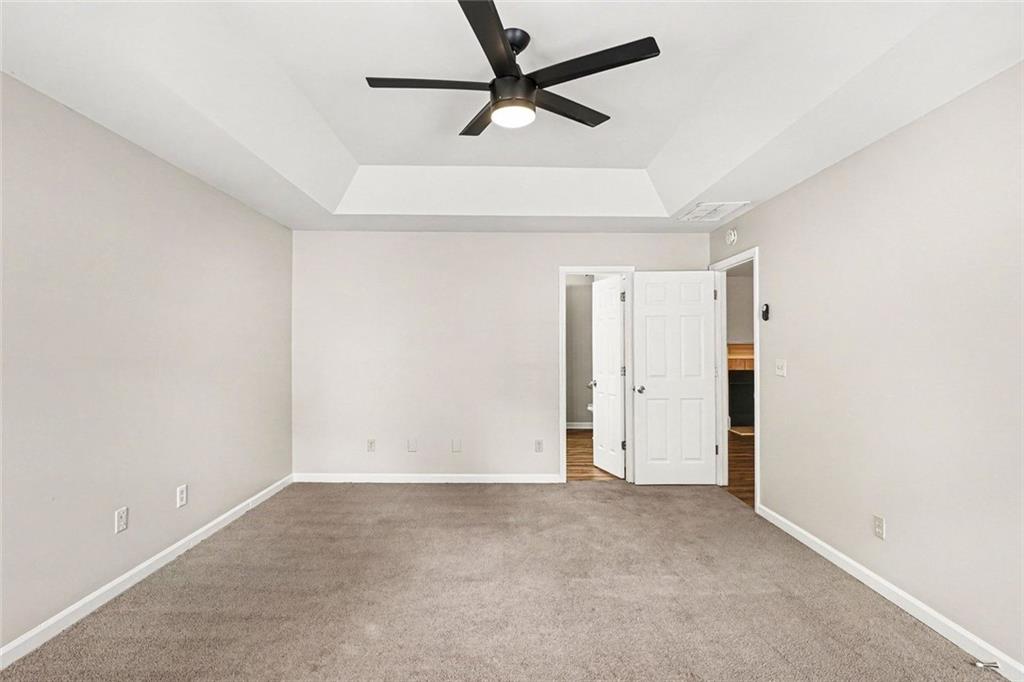 120 Beaverdam Court Covington, GA 30016 - Photo 7 of 20 an empty room with a ceiling fan and carpet