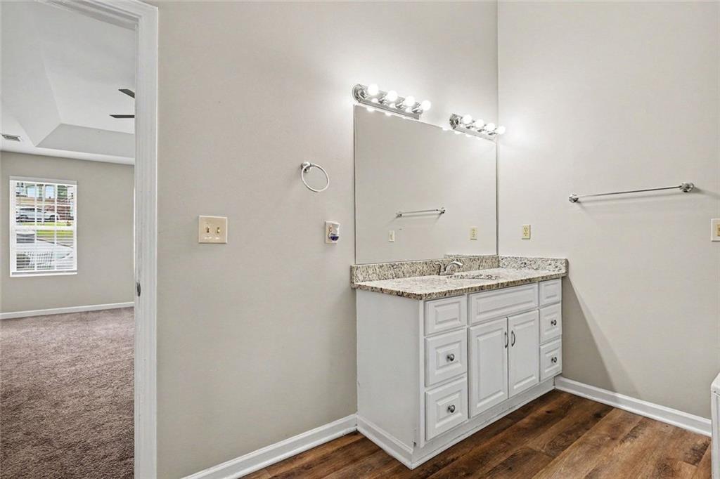 120 Beaverdam Court Covington, GA 30016 - Photo 8 of 20 a bathroom with a granite countertop sink a mirror and a shower