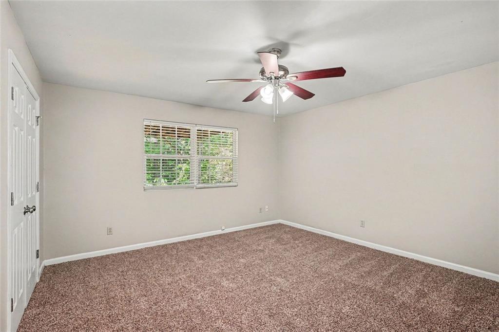120 Beaverdam Court Covington, GA 30016 - Photo 10 of 20 an empty room with a window and a fan